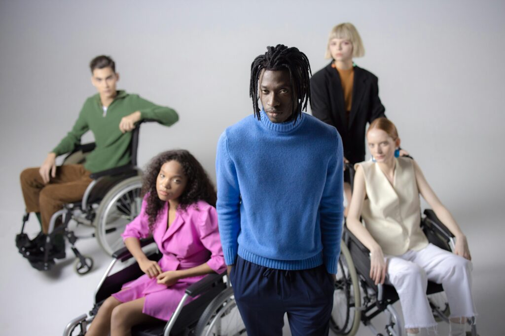People Sitting on the Wheelchair in the White Studio